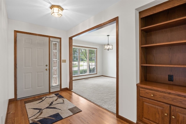 3629 Timberline Dr NE, Cedar Rapids, IA 52402 - entryway featuring baseboards, a chandelier, and light wood finished floors