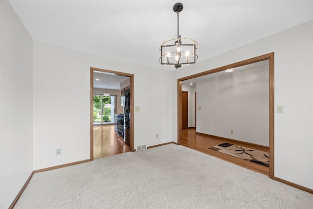 3629 Timberline Dr NE, Cedar Rapids, IA 52402 - empty room featuring carpet flooring, a chandelier, and baseboards