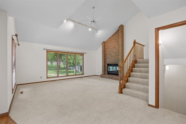 3629 Timberline Dr NE, Cedar Rapids, IA 52402 - unfurnished living room featuring track lighting, carpet, a fireplace, and high vaulted ceiling