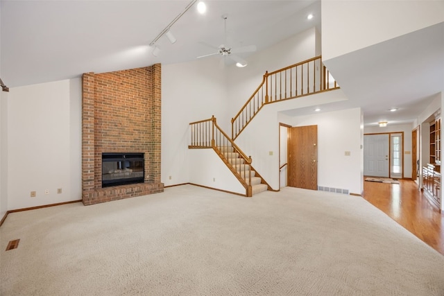 3629 Timberline Dr NE, Cedar Rapids, IA 52402 - unfurnished living room featuring stairway, carpet flooring, a ceiling fan, a fireplace, and baseboards