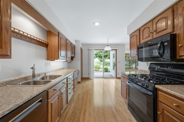 3629 Timberline Dr NE, Cedar Rapids, IA 52402 - kitchen featuring black appliances, a sink, light wood finished floors, brown cabinetry, and hanging light fixtures