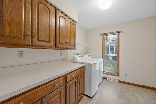 3629 Timberline Dr NE, Cedar Rapids, IA 52402 - washroom featuring cabinet space, baseboards, washer and dryer, and light tile patterned floors