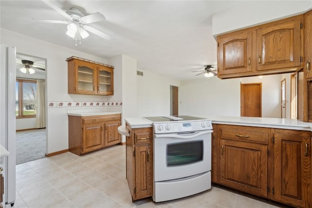 6405 Hillcrest Rd, Cedar Rapids, IA 52404 - kitchen with white range with electric cooktop, a ceiling fan, and brown cabinets