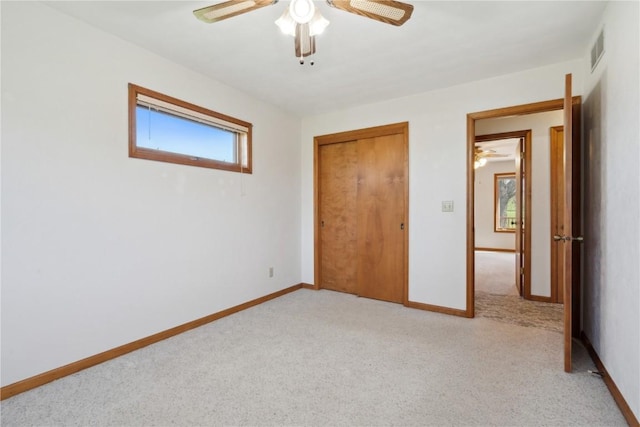 6405 Hillcrest Rd, Cedar Rapids, IA 52404 - unfurnished bedroom featuring light carpet, baseboards, a closet, and ceiling fan