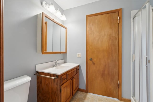 6405 Hillcrest Rd, Cedar Rapids, IA 52404 - bathroom with vanity, a stall shower, toilet, and baseboards
