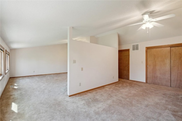 6405 Hillcrest Rd, Cedar Rapids, IA 52404 - unfurnished bedroom with lofted ceiling, carpet flooring, a ceiling fan, and multiple closets