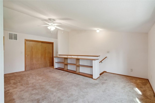 6405 Hillcrest Rd, Cedar Rapids, IA 52404 - empty room with carpet floors, a ceiling fan, lofted ceiling, and baseboards