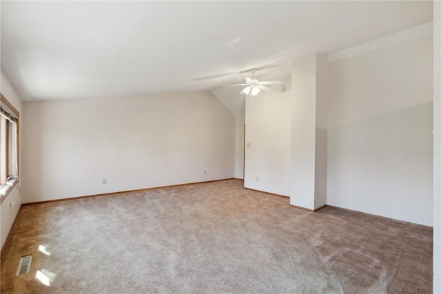 6405 Hillcrest Rd, Cedar Rapids, IA 52404 - empty room with a ceiling fan, carpet flooring, vaulted ceiling, and baseboards