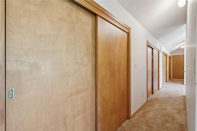 6405 Hillcrest Rd, Cedar Rapids, IA 52404 - hallway with lofted ceiling and light carpet
