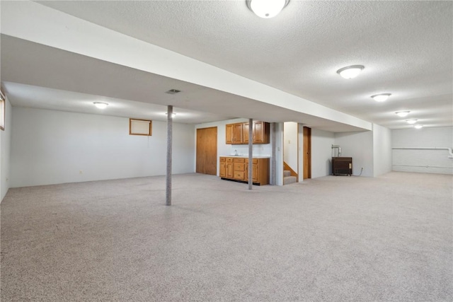 6405 Hillcrest Rd, Cedar Rapids, IA 52404 - finished below grade area featuring a textured ceiling and stairway