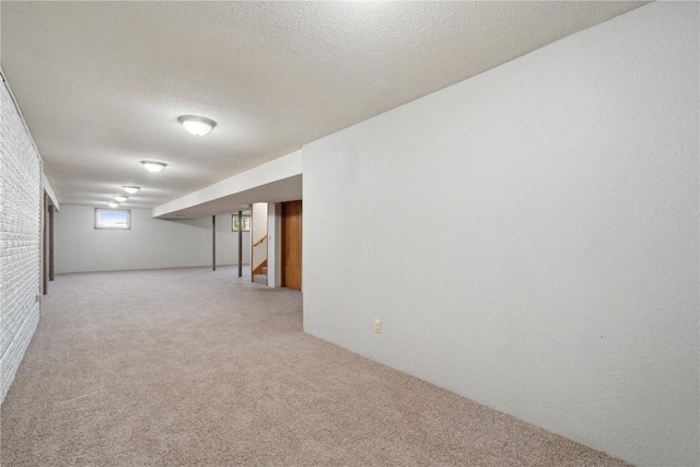 6405 Hillcrest Rd, Cedar Rapids, IA 52404 - basement featuring light colored carpet, stairs, and a textured ceiling