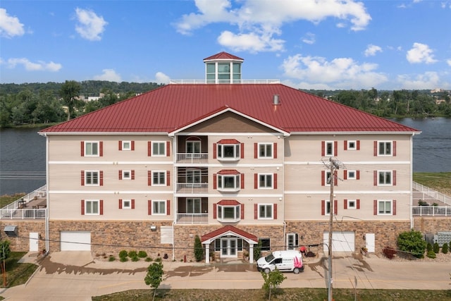 1871 Ellis Blvd NW Unit 309, Cedar Rapids, IA 52405 - view of building exterior with a water view, a garage, and driveway