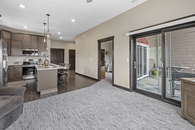 1871 Ellis Blvd NW Unit 309, Cedar Rapids, IA 52405 - kitchen with appliances with stainless steel finishes, open floor plan, light countertops, baseboards, and a breakfast bar area