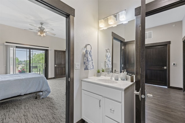 1871 Ellis Blvd NW Unit 309, Cedar Rapids, IA 52405 - bathroom featuring vanity, a ceiling fan, baseboards, ensuite bath, and wood finished floors