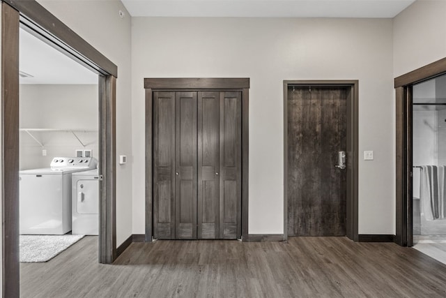 1871 Ellis Blvd NW Unit 309, Cedar Rapids, IA 52405 - unfurnished bedroom featuring independent washer and dryer, wood finished floors, baseboards, and multiple closets