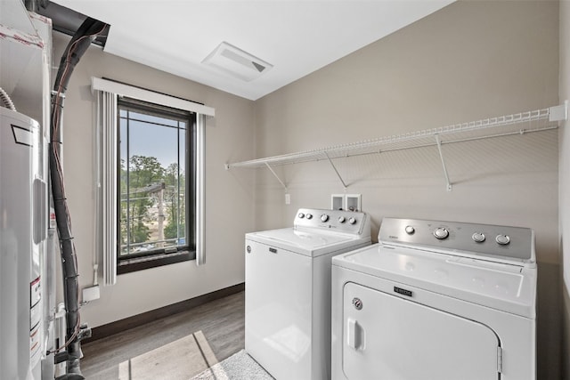 1871 Ellis Blvd NW Unit 309, Cedar Rapids, IA 52405 - laundry room featuring separate washer and dryer, light wood-style flooring, and baseboards