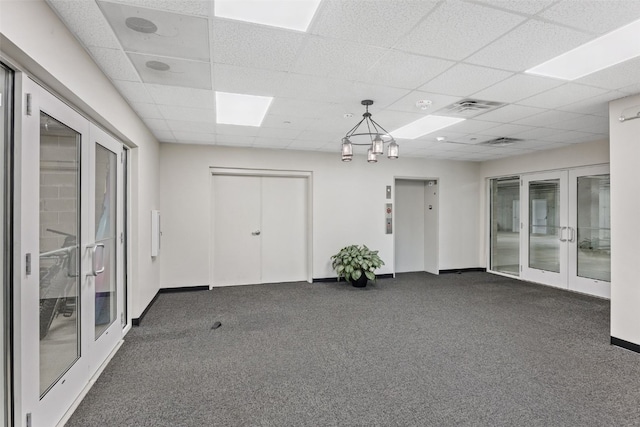 1871 Ellis Blvd NW Unit 309, Cedar Rapids, IA 52405 - carpeted spare room with french doors, elevator, a paneled ceiling, and baseboards