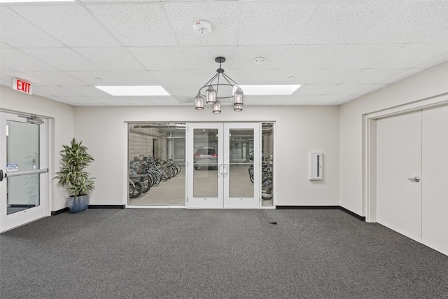 1871 Ellis Blvd NW Unit 309, Cedar Rapids, IA 52405 - empty room with french doors, baseboards, carpet flooring, a paneled ceiling, and a smoke detector