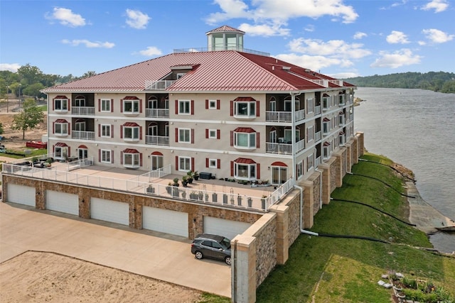 1871 Ellis Blvd NW Unit 309, Cedar Rapids, IA 52405 - view of building exterior featuring a water view, driveway, and a garage