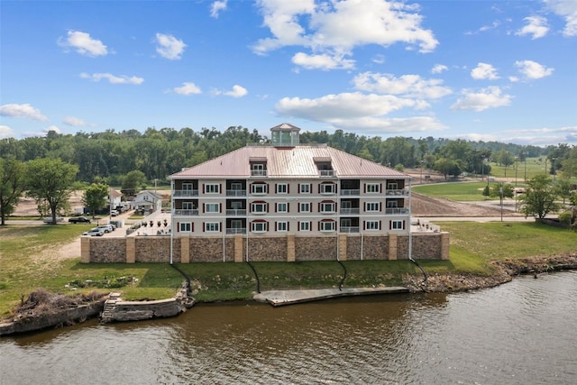 1871 Ellis Blvd NW Unit 309, Cedar Rapids, IA 52405 - rear view of house with stone siding, a water view, metal roof, and a yard