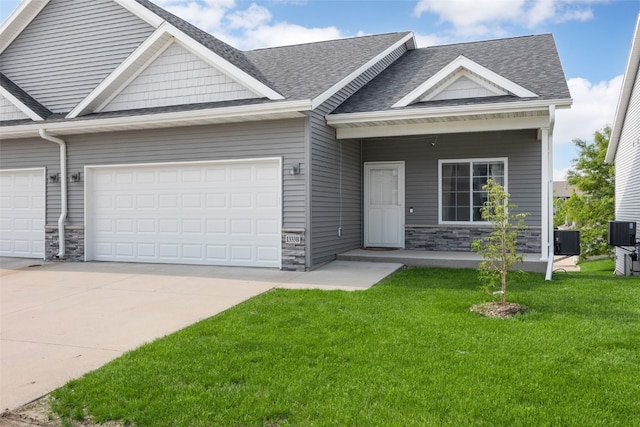 1333 Truman Ct NE Unit B, Cedar Rapids, IA 52402 - view of front of property featuring a garage, stone siding, and driveway