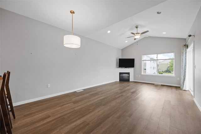 1333 Truman Ct NE Unit B, Cedar Rapids, IA 52402 - unfurnished living room featuring lofted ceiling, wood finished floors, a glass covered fireplace, ceiling fan, and recessed lighting