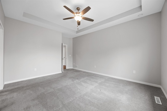 1333 Truman Ct NE Unit B, Cedar Rapids, IA 52402 - carpeted empty room featuring a tray ceiling, a ceiling fan, and baseboards