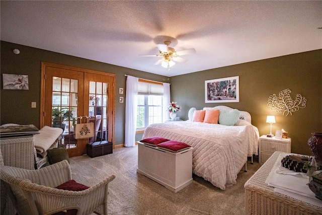 1701 130th St Unit 306, Anamosa, IA 52205 - bedroom featuring light carpet, french doors, a ceiling fan, and access to outside