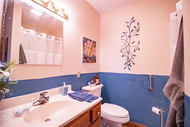 1701 130th St Unit 306, Anamosa, IA 52205 - bathroom featuring toilet, vanity, and a shower with shower curtain