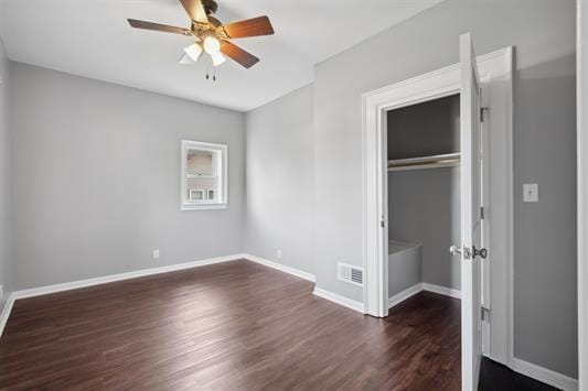 611 3rd Ave NE, Independence, IA 50644 - unfurnished bedroom with dark wood-style flooring, a closet, baseboards, and a ceiling fan