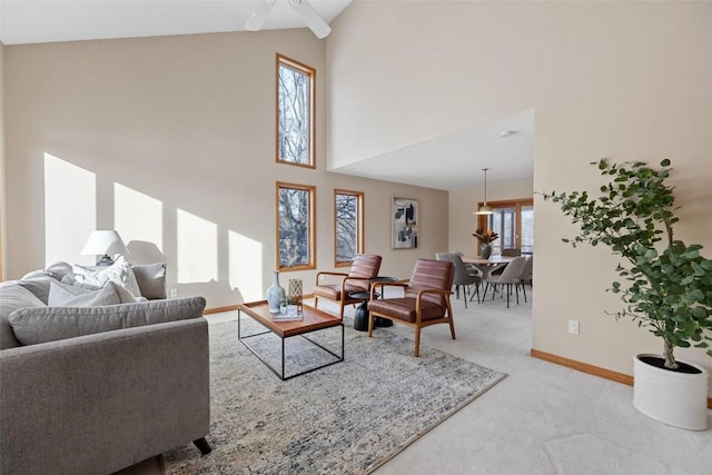 4644 Rapid Creek Trl NE, Iowa City, IA 52240 - living area featuring light colored carpet, a towering ceiling, and a ceiling fan