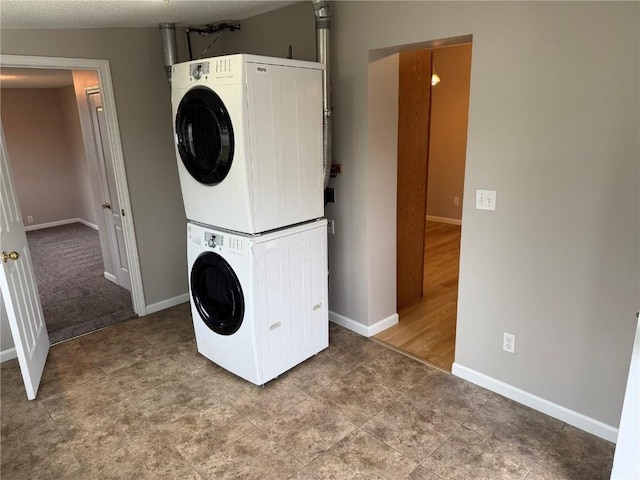 1101 Elmhurst Dr NE, Cedar Rapids, IA 52402 - laundry room with stacked washer / drying machine and baseboards
