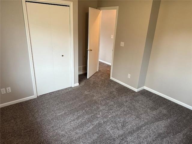 1101 Elmhurst Dr NE, Cedar Rapids, IA 52402 - unfurnished bedroom with dark colored carpet, baseboards, and a closet