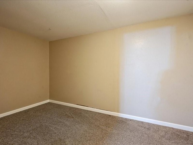 751 30th St NE, Cedar Rapids, IA 52402 - spare room with dark colored carpet and baseboards
