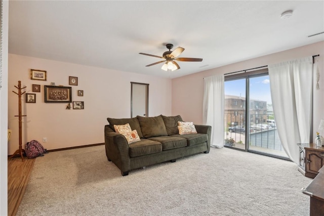 1015 Woodland Heights Ct SE Unit 14, Cedar Rapids, IA 52403 - carpeted living room featuring ceiling fan and baseboards