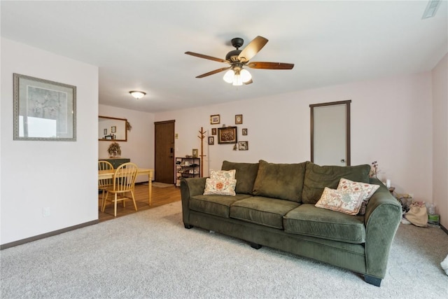 1015 Woodland Heights Ct SE Unit 14, Cedar Rapids, IA 52403 - living room featuring carpet, a ceiling fan, and baseboards