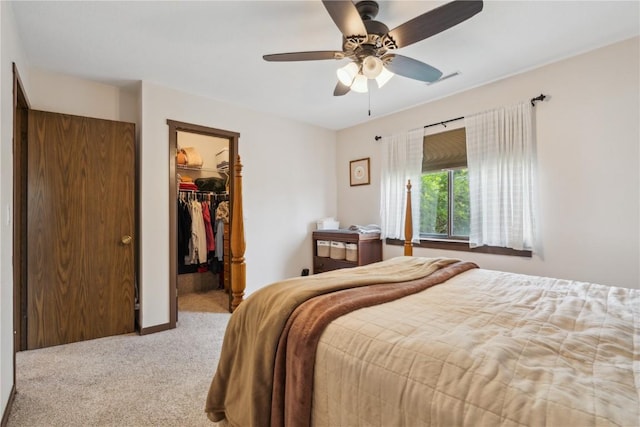 1015 Woodland Heights Ct SE Unit 14, Cedar Rapids, IA 52403 - bedroom featuring carpet, a walk in closet, a closet, a ceiling fan, and baseboards