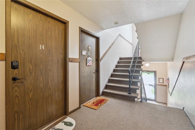 1015 Woodland Heights Ct SE Unit 14, Cedar Rapids, IA 52403 - staircase with carpet flooring and a textured ceiling
