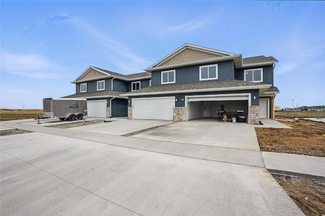 2004 Croell Ave, Tiffin, IA 52340 - view of front facade with a garage, stone siding, and concrete driveway