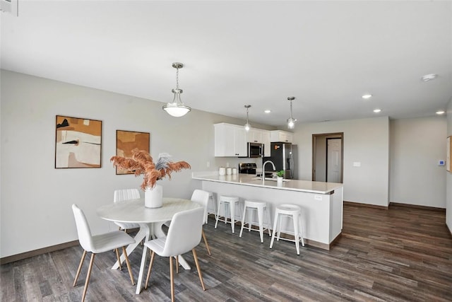 2004 Croell Ave, Tiffin, IA 52340 - dining space featuring recessed lighting, dark wood-style flooring, and baseboards