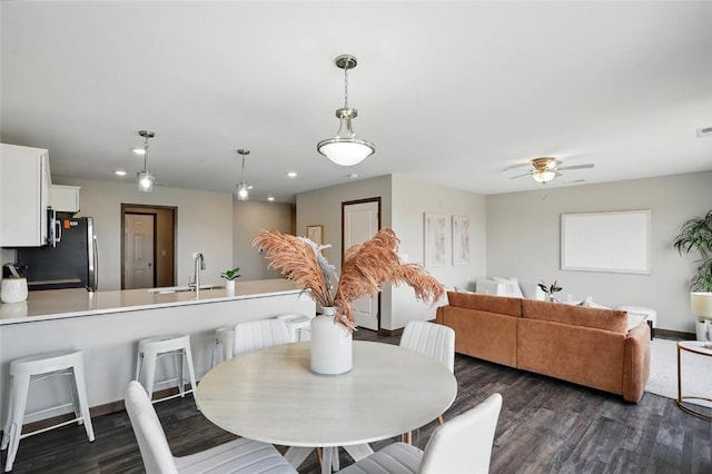 2004 Croell Ave, Tiffin, IA 52340 - dining space with dark wood-style flooring, a ceiling fan, recessed lighting, and baseboards
