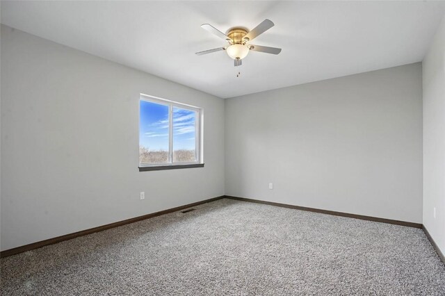 2004 Croell Ave, Tiffin, IA 52340 - carpeted empty room featuring ceiling fan and baseboards