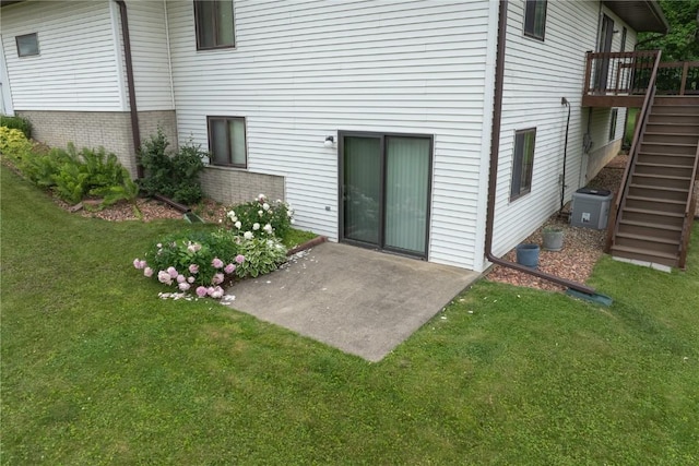 109 Oreole NE, Solon, IA 52333 - back of house featuring stairway, a patio, a lawn, and a wooden deck