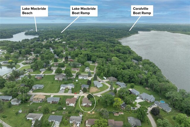 109 Oreole NE, Solon, IA 52333 - aerial overview of property's location with a nearby body of water, a heavily wooded area, and nearby suburban area