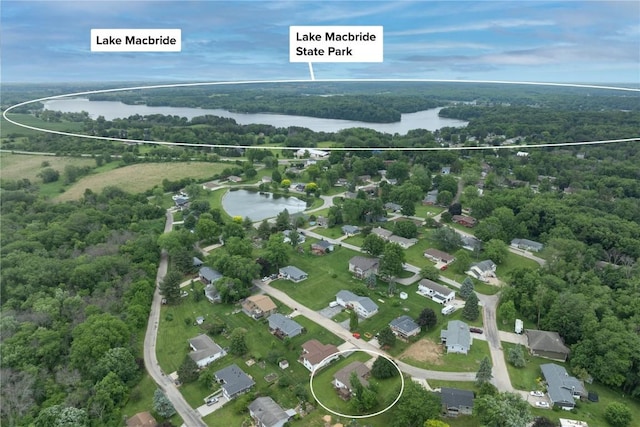 109 Oreole NE, Solon, IA 52333 - aerial view of property and surrounding area featuring a large body of water and a heavily wooded area