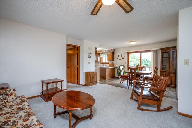 109 Oreole NE, Solon, IA 52333 - living room with a textured ceiling, a ceiling fan, and light colored carpet