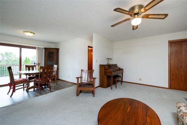 109 Oreole NE, Solon, IA 52333 - carpeted dining space with ceiling fan, a textured ceiling, and baseboards