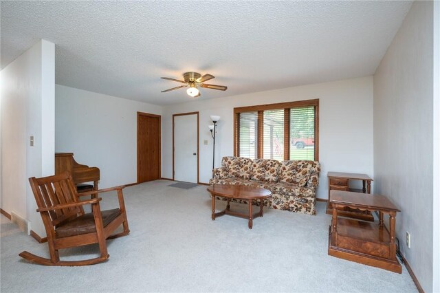 109 Oreole NE, Solon, IA 52333 - living area featuring a ceiling fan, carpet flooring, and a textured ceiling