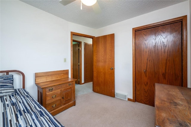 109 Oreole NE, Solon, IA 52333 - bedroom featuring light carpet, a textured ceiling, and a ceiling fan