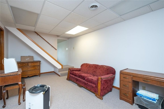 109 Oreole NE, Solon, IA 52333 - living area featuring carpet, stairs, baseboards, and a drop ceiling